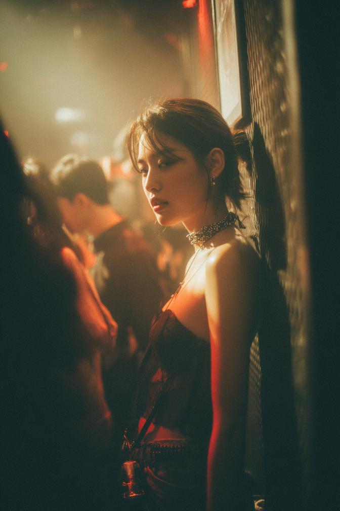 KL Escort Girl KL Escort Girl in a dimly lit club, wearing a choker and corset top, leaning against a wall. Malaysia Sex Service