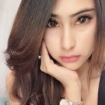 KL Escort Girl Attractive woman with long brown hair and a watch posing for a selfie. Malaysia Sex Service
