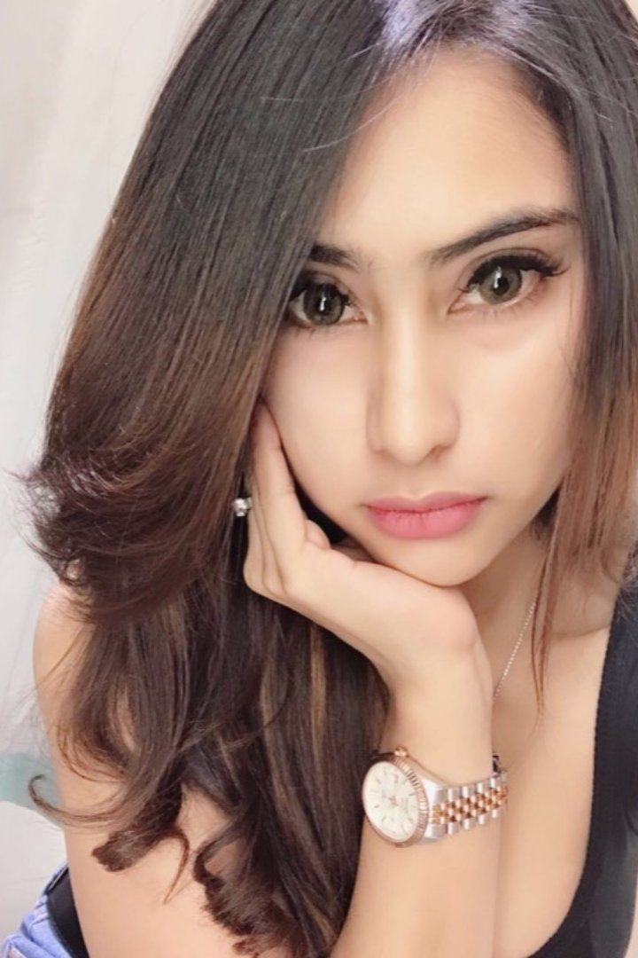KL Escort Girl Attractive woman with long brown hair and a watch posing for a selfie. Malaysia Sex Service