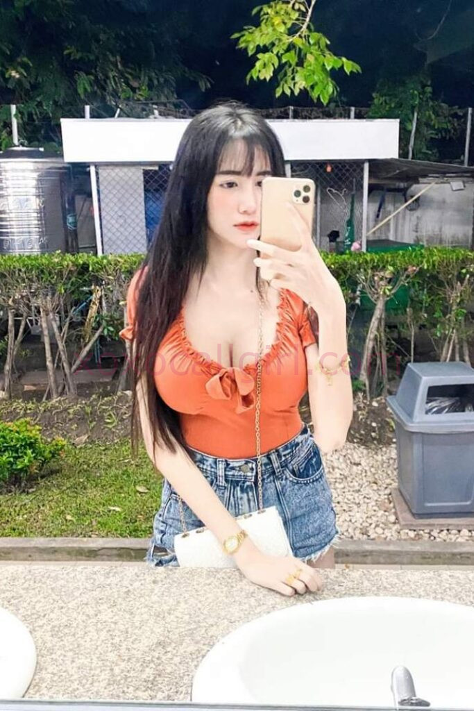 KL Escort Girl Woman holding a sign that reads "Malay Escort.site" on a black background. Malaysia Sex Service