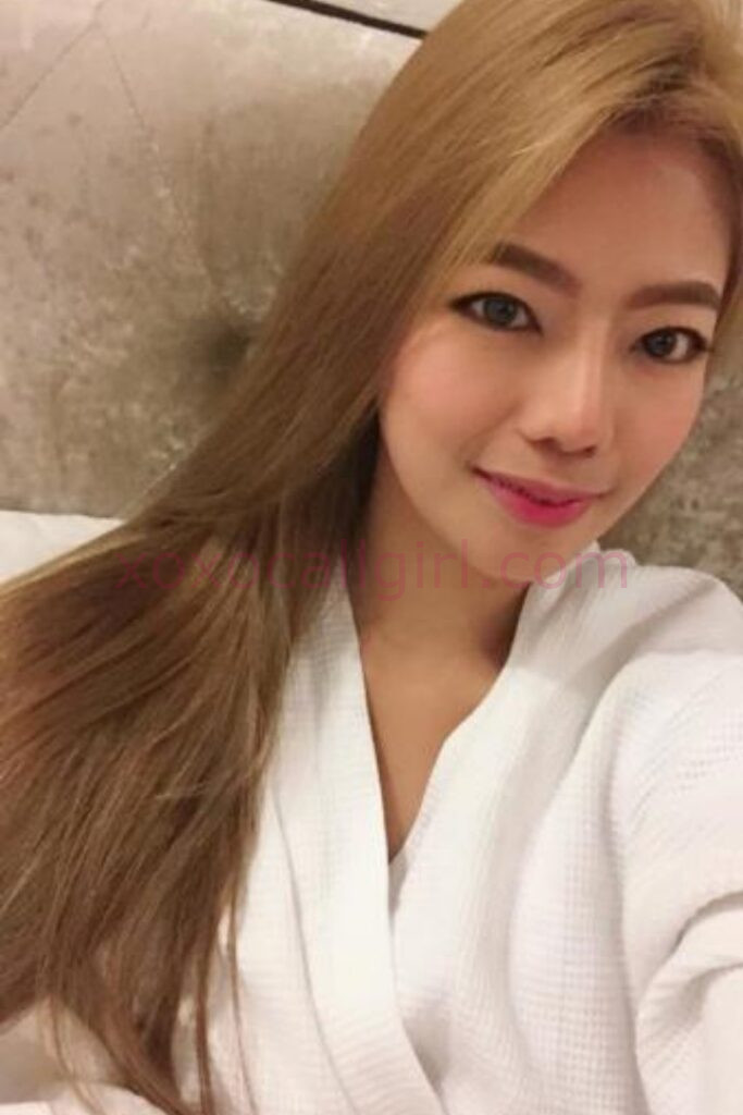 KL Escort Girl Elaiza, a Local Chinese Escort in Kuala Lumpur, wearing a white robe and smiling. Malaysia Sex Service