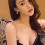 KL Escort Girl Elegant woman in black dress with jewelry. Sophisticated fashion. Malaysia Sex Service