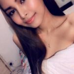 KL Escort Girl Portrait of a beautiful woman with long brown hair and a white top. Malaysia Sex Service