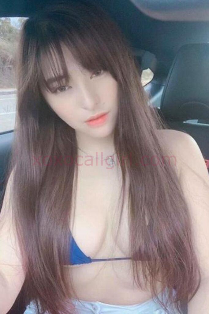KL Escort Girl Malay Escort Girl Umaira in Kuala Lumpur, wearing a blue top, seated in a car. Malaysia Sex Service