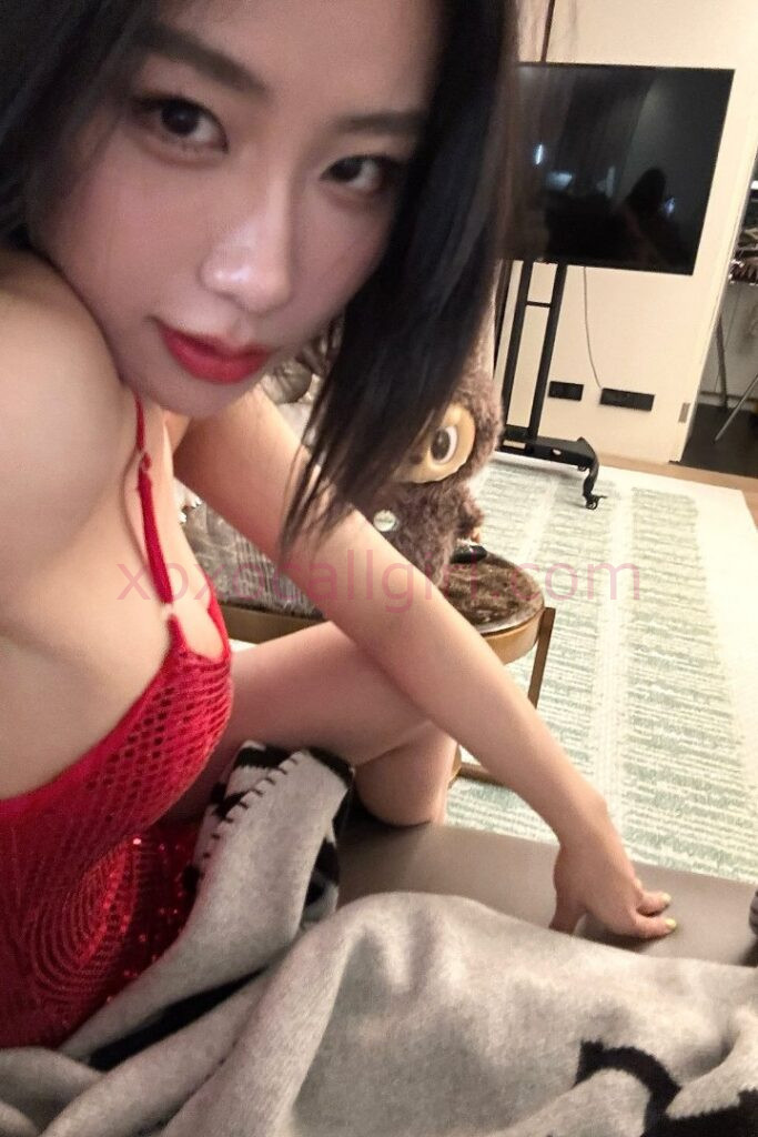 KL Escort Girl Woman in blue lingerie with black lace details, posing near a bed. Malaysia Sex Service