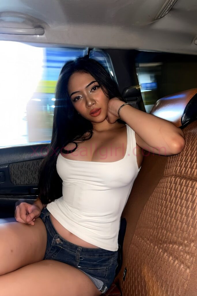 KL Escort Girl Malay Escort in Kuala Lumpur wearing a white top and denim shorts in a car. Malaysia Sex Service