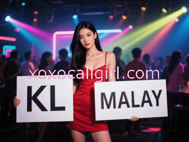 KL Escort Girl Young Asian woman in black top and red shorts sitting on bed with Hello Kitty background. Malaysia Sex Service